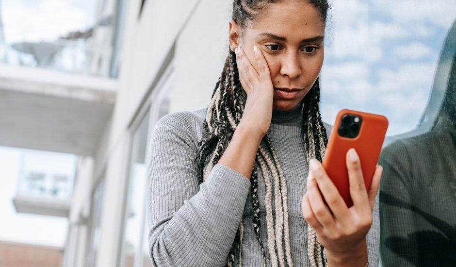 Nomofobi yaşayan bir kişi telefonuna kaygıyla bakıyor