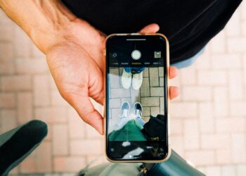 Phubbing yapan bir kişi masada telefona bakıyor